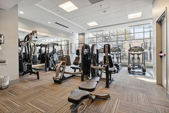 A gym with weights and cardio equipment in a building